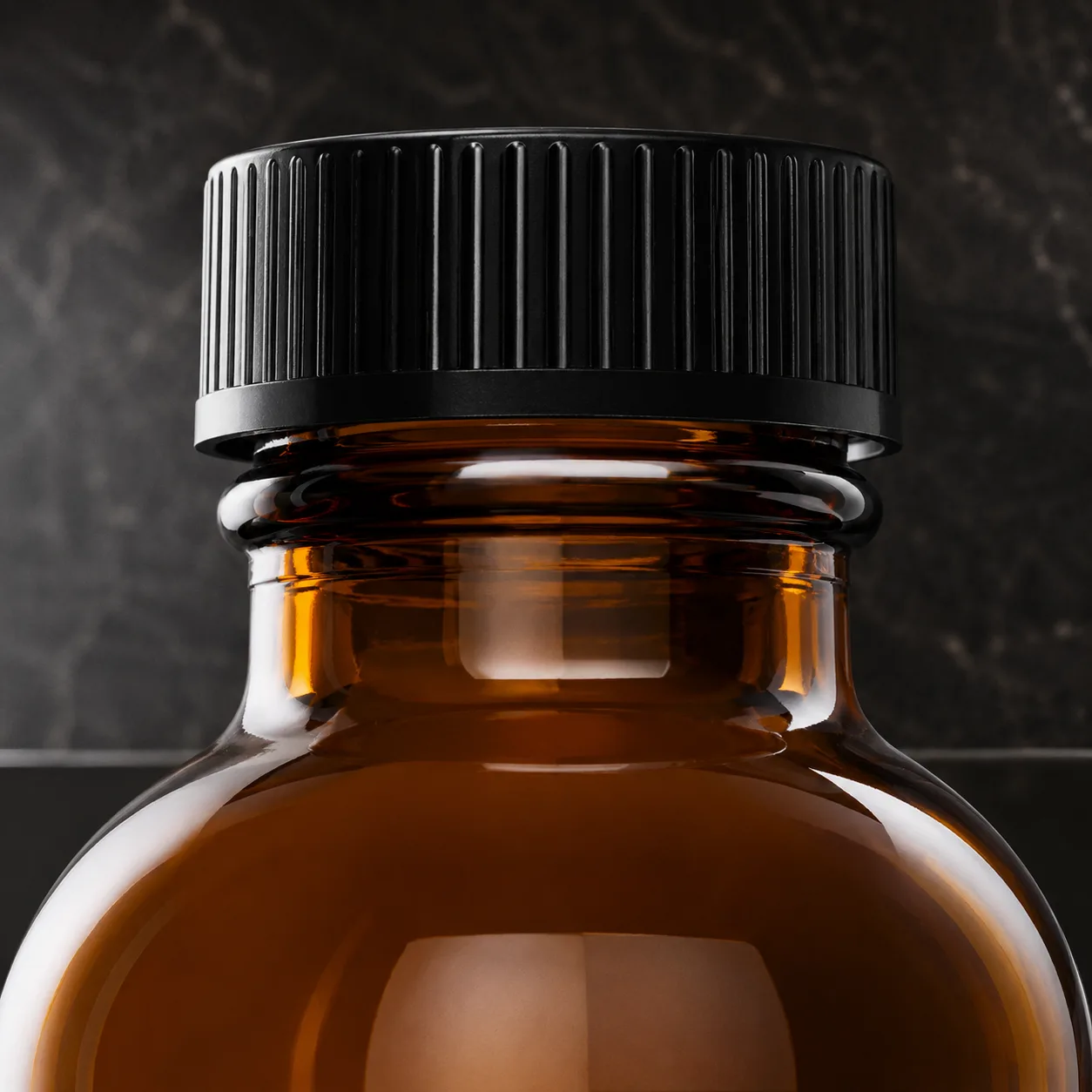 Close view of Amber Glass Apothecary Bottle showing label area and print / coat / label