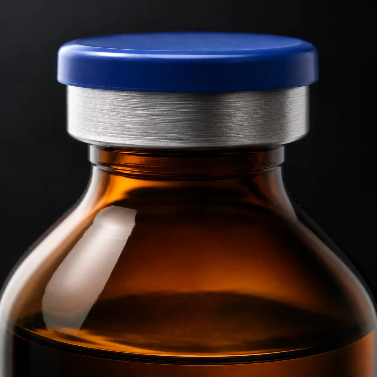 Close view of Amber Round-Shoulder Glass Bottle showing label area and print / coat / label