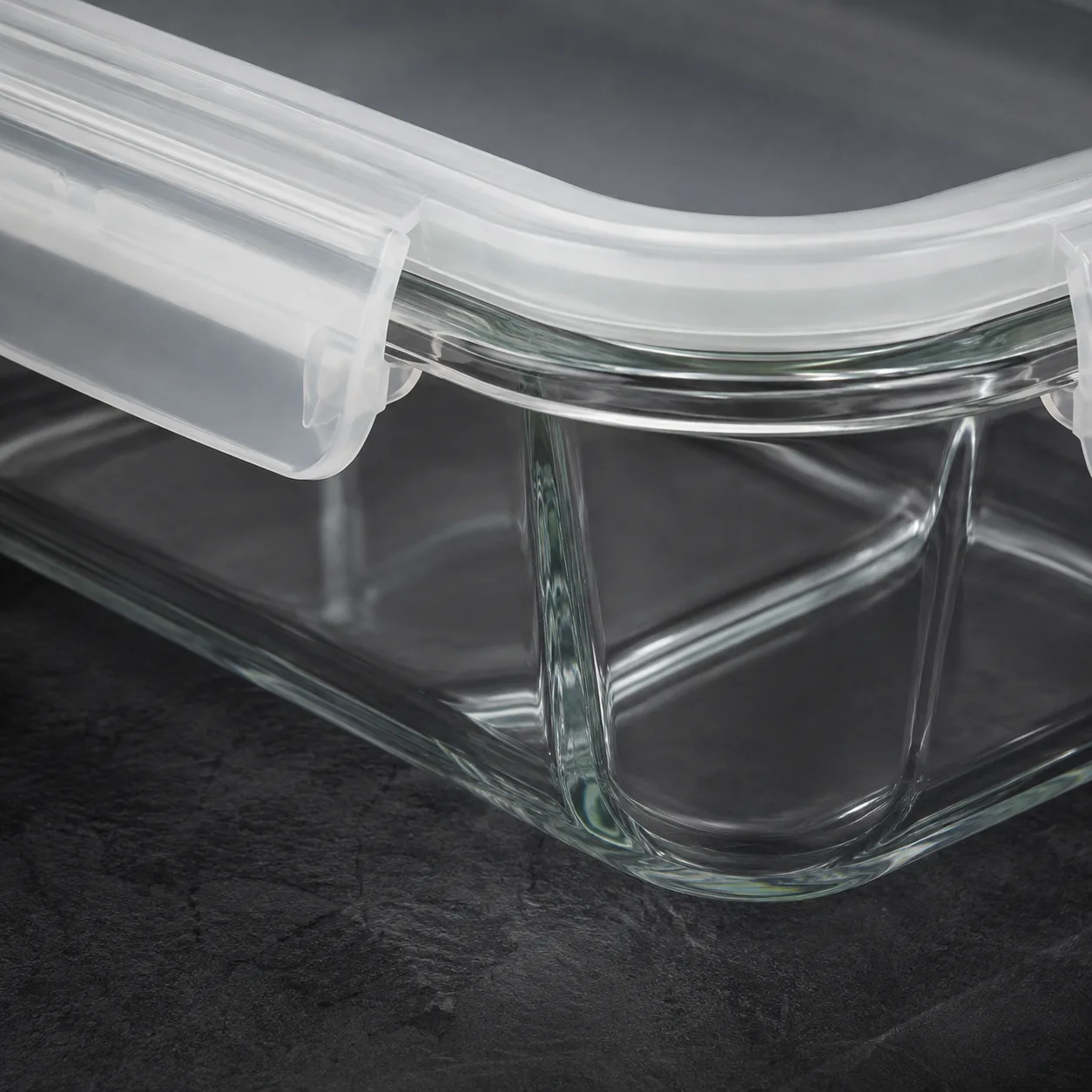 Close view of Divided Glass Meal Prep Container showing glass wall and label / lid branding