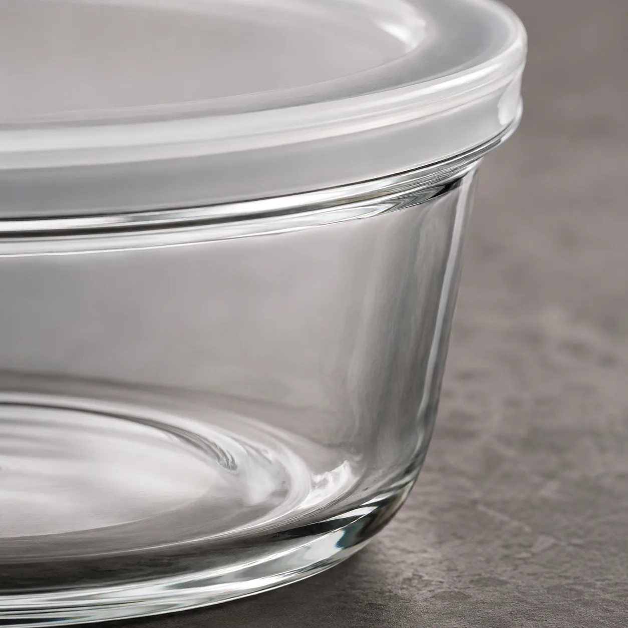 Close view of Round Glass Food Storage Bowl showing glass wall and label / lid branding