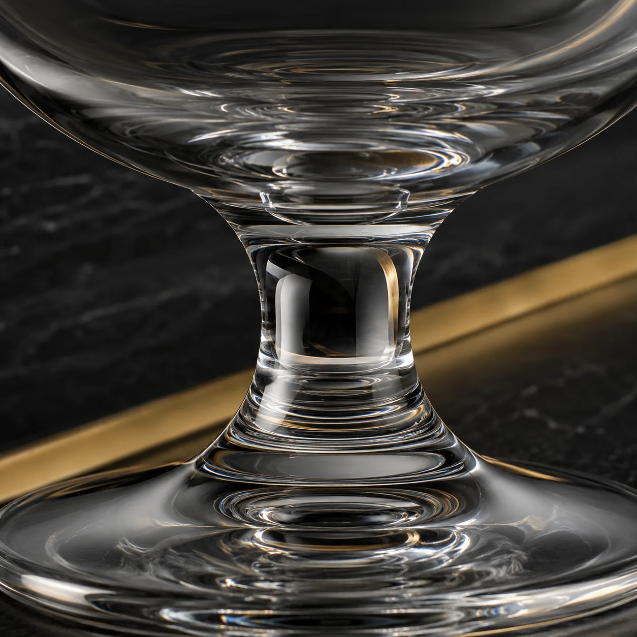Close view of Brandy Snifter Glass showing stem or base and logo print / decal